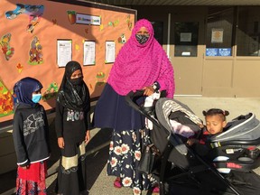 Mom Haredo Hassan, with one-year-old Aisha, drops off daughters Shamso, 7 and in Grade 2, and Khadija, 9 and in Grade 4, at Strawberry Hill Elementary in Surrey.