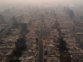 A haze from wildfire smoke lingers over the gutted Medford Estates neighbourhood in the aftermath of the Almeda fire in Medford, Ore., on Sept. 10, 2020. Picture taken with a drone.