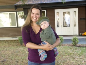 Danielle Harris holds her six-month-old daughter Alexandra in front of her Langley home. Harris says she will be voting for NDP candidate Andrew Mercier because the party's policies reflect what she wants to see in a provincial government.