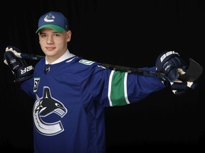 Vasili Podkolzin poses for a portrait after being selected 10th overall by the Vancouver Canucks during the first round of the 2019 NHL Entry Draft at Rogers Arena in Vancouver.