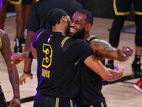 Lakers’ LeBron James (right) celebrates with Anthony Davis after the big centre sank a three-point basket to beat the Nuggets in Game 2 of their series on Sunday.