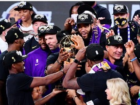 The Los Angeles Lakers celebrate with the trophy after winning the 2020 NBA Championship Final over the Miami Heat in Game Six of the 2020 NBA Finals at AdventHealth Arena at the ESPN Wide World Of Sports Complex on October 11, 2020 in Lake Buena Vista, Florida.