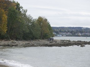 People on the beach at Kits Point in Vancouver on Oct. 19, 2020.