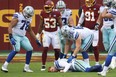 Dallas Cowboys quarterback Andy Dalton lies on the field after being hit by Washington linebacker Jon Bostic (53) and knocked out of the game in the third quarter at FedExField last Sunday.