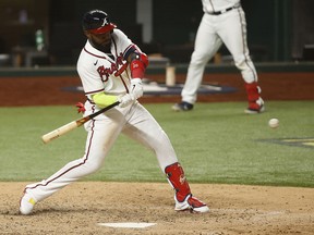 Atlanta Braves designated hitter Marcell Ozuna hits a home run against the Los Angeles Dodgers during the seventh inning of Game 4 of the 2020 NLCS at Globe Life Field.