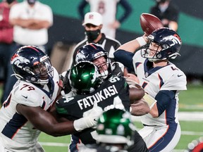 Denver Broncos quarterback Brett Rypien throws as New York Jets defensive tackle Foley Fatukasi (94) defends during the second half at MetLife Stadium.
