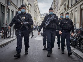 Armed police secure the area around the former Charlie Hebdo headquarters, and scene of a previous terrorist attack in 2015, after two people were stabbed on Sept. 25, 2020 in Paris, France.