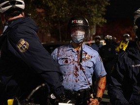 Riot police officer stands during clashes at a rally after the death of Walter Wallace Jr., a Black man who was shot by police in Philadelphia, Pennsylvania, U.S., October 27, 2020.