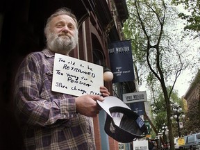 Former Vancouver Sun reporter Bob Sarti protesting by panhandling in Gastown's Maple Tree Square in 2000.