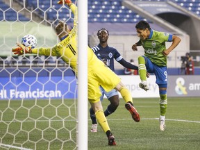 Seattle Sounders FC forward Raul Ruidiaz (9) scores his second goal of the second half in front of Vancouver Whitecaps midfielder Janio Bikel against the Vancouver Whitecaps at CenturyLink Field on Saturday.