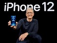 Apple CEO Tim Cook poses with the all-new iPhone 12 Pro at Apple Park in Cupertino, Calif., in a photo released Oct. 13, 2020.