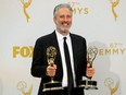 Jon Stewart holds his awards for Outstanding Writing For A Variety Series and Outstanding Variety Talk Series for Comedy Central's "The Daily Show With Jon Stewart" during the 67th Primetime Emmy Awards in Los Angeles, California September 20, 2015.