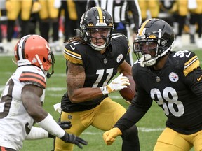 Pittsburgh Steelers wide receiver Chase Claypool (11) runs past Cleveland Browns cornerback Terrance Mitchell (39) to follow blocking by running back Jaylen Samuels (38) as he runs for a touchdown during the second half of an NFL football game, Sunday, Oct. 18, 2020, in Pittsburgh.