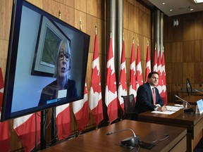 Immigration, Refugees and Citizenship Minister Marco Mendicino watches Health Minister Patty Hajdu speak via video conference during a news conference in Ottawa, Friday, Oct. 2, 2020.