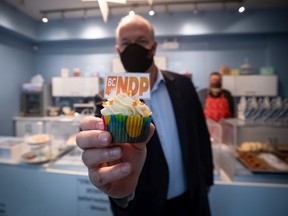 NDP Leader John Horgan holds a party-branded cupcake during a campaign stop at a cupcake shop, in Pitt Meadows, B.C., on Friday. A provincial election will be held in British Columbia on October 24.