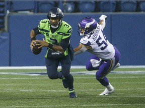 Seattle Seahawks quarterback Russell Wilson (3) escapes from Minnesota Vikings middle linebacker Eric Kendricks (54) during the fourth quarter at CenturyLink Field.