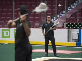Vancouver Warriors coach Chris Gill catches a ball from Warriors' star Mitch Jones at Rogers Arena.