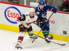 Veteran defenceman Oliver Ekman-Larsson of the Arizona Coyotes, left, sticks close to Adam Gaudette of the Vancouver Canucks during NHL action earlier this year. Is it possible the two could become teammates next season?
