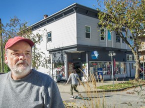Heritage expert John Atkin in front of corner store at Yew and West 6th Ave. in Vancouver.