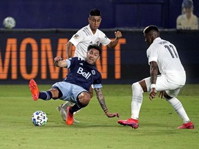 Vancouver Whitecaps defender Erik Godoy (22) loses his footing as LA Galaxy midfielder Yony Gonzalez (11) defends the play during the first half at Dignity Health Sports Park.