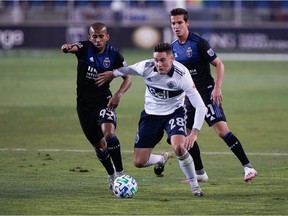 Vancouver Whitecaps defender Jake Nerwinski (28) controls the ball against San Jose Earthquakes midfielder Judson (93) and midfielder Carlos Fierro (21) during the first half at Avaya Stadium during the Quakes' 3-0 win on Oct. 7.