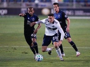 Whitecaps defender Jake Nerwinski chases the ball with a pair of San Jose Earthquakes in pursuit during an MLS game last season at San Jose’s Avaya Stadium. ‘I think it’s really nice to see that they value my play and value what I’ve done for this club,’ Nerwinski says of his new, two-year contract extension.