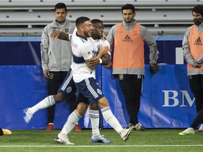 Vancouver Whitecaps forward Lucas Cavallini, foreground, celebrates with midfielder Cristian Dajome after scoring in the first half at Providence Park on Oct. 14 in Portland, Ore.