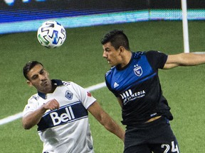 San Jose Earthquakes defender Nick Lima heads the ball away from Vancouver Whitecaps defender Ali Adnan during the first half at Providence Park.