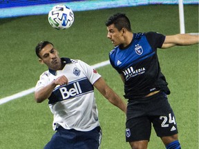 San Jose Earthquakes defender Nick Lima (24) heads the ball away from Vancouver Whitecaps defender Ali Adnan during at Providence Park.