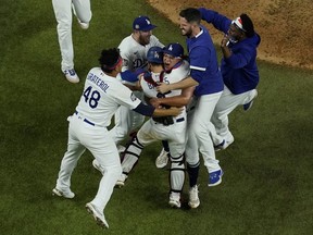 Los Angeles Dodgers celebrate after defeating the Tampa Bay Rays 3-1 to win the baseball World Series in Game 6 Tuesday, Oct. 27, 2020, in Arlington, Texas.
