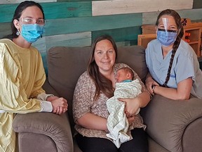 Midwives Josée Gervais and Joanna Norman with mom Karen Enns, who opted to give birth at home because of the pandemic.