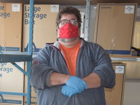 Chris Bayliss, executive director of the Lower Mainland Christmas Bureau, stands next to shelves that will be taken down to allow the Vancouver-based charitable group to open up more space and comply with social-distancing guidelines in time for the holiday season.