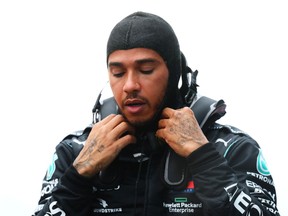 Race winner Lewis Hamilton of Great Britain and Mercedes GP removes his safety gear as he celebrates winning a seventh F1 world drivers championship at the Turkish Grand Prix on Nov. 15, 2020 in Istanbul.
