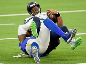 Quarterback Russell Wilson #3 of the Seattle Seahawks is sacked by Michael Brockers #90 of the Los Angeles Rams in the fourth quarter at SoFi Stadium on November 15, 2020.