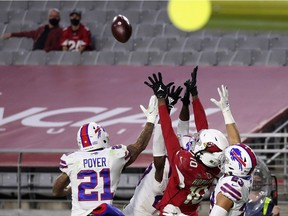 Wide receiver DeAndre Hopkins #10 of the Arizona Cardinals catches the game winning 43-yard touchdown over Micah Hyde #23, Jordan Poyer #21 and Tre'Davious White #27 of the Buffalo Bills during the final moments of NFL game at State Farm Stadium on November 15, 2020 in Glendale, Arizona. The Cardinals defeated the Bills 32-30.