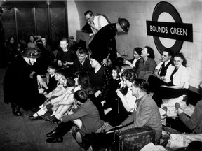 Sheltering from air raids at Bound's Green Underground station, London