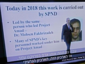 A file photo taken on April 30, 2018, shows a television at a hairdresser's salon in Jerusalem, broadcasting Israeli Prime Minister Benjamin Netanyahu's speech on Iran's nuclear program with a slide picturing Iranian scientist Mohsen Fakhrizadeh.