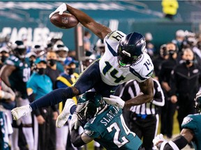Seattle Seahawks wide receiver DK Metcalf (14) attempts to leap over the tackle of Philadelphia Eagles cornerback Darius Slay (24) during the second quarter at Lincoln Financial Field.