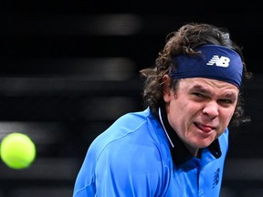 Milos Raonic eyes the ball as he returns it to Daniil Medvedev during their men's singles semifinal match at the Paris Masters in Paris, Saturday, Nov. 7, 2020.