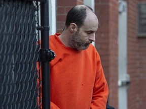 Matthew Vincent Raymond is escorted from Court of Queen's Bench in Fredericton, Dec. 18, 2019.