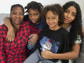Rosmira Valencia with children Emmanuel, 11, Dylan, 7, and Valerie, 14, at their Burnaby home on Saturday.