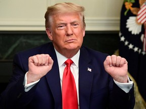 President Donald Trump gestures as he participates in a Thanksgiving video teleconference with members of the military forces at the White House in Washington November 26, 2020.