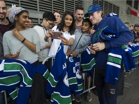 There won't be any scenes like this between Brock Boeser and fans if the NHL resumes play as planned on Jan. 13. The league plans to start the season in empty arenas.