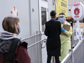 A nurse greets patients at a COVID-19 walk-in clinic in Montreal, on Tuesday, September 29, 2020.