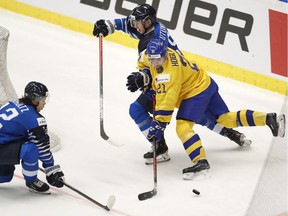 Viktor Persson is hoping to follow in the footsteps of other Canucks prospects like Toni Utunen and Nils Hoglander, seen here battling for the puck at the 2020 World Junior Championship.