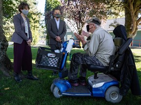 Green Party Leader Sonia Furstenau, left, and local candidate Jeremy Valeriote, second left, listen to Jules Anderson, who said he was living in a homeless shelter, after a campaign stop in Squamish, B.C., on Tuesday, September 29, 2020. A judicial recount will determine whether Valeriote won.