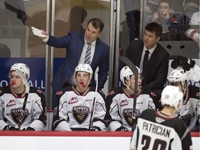 Assistant coach Jamie Heward, left, and Vancouver Giants head coach Michael Dyck work a game against the Pats in Regina last year.