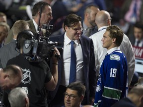 Nils Hoglander chats with Canucks owner Francesco Aquilini at the NHL Draft in June, 2019.