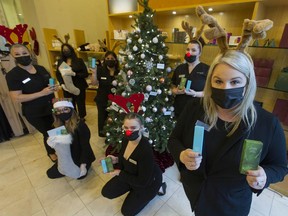 Absolute Spa's Jill Bryan (right) with other employees of the Vancouver with items that will be sold to benefit the Empty Stocking Fund this Christmas.