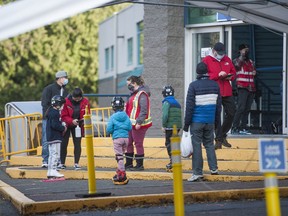 Parents drop off their children for skating lessons at Scotia Barn in Burnaby on Saturday. The facility has a strict COVID-19 screening system in-place, making kids sports as safe as possible.